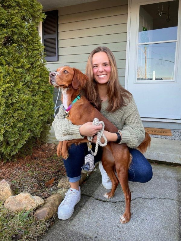 APSC Outstanding Senior, Melissa Pineda-Perez smiling while holding a dog. 2022.