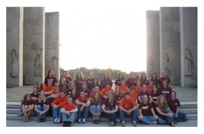 Dairy Club in maroon and orange on the steps of the Pylons.